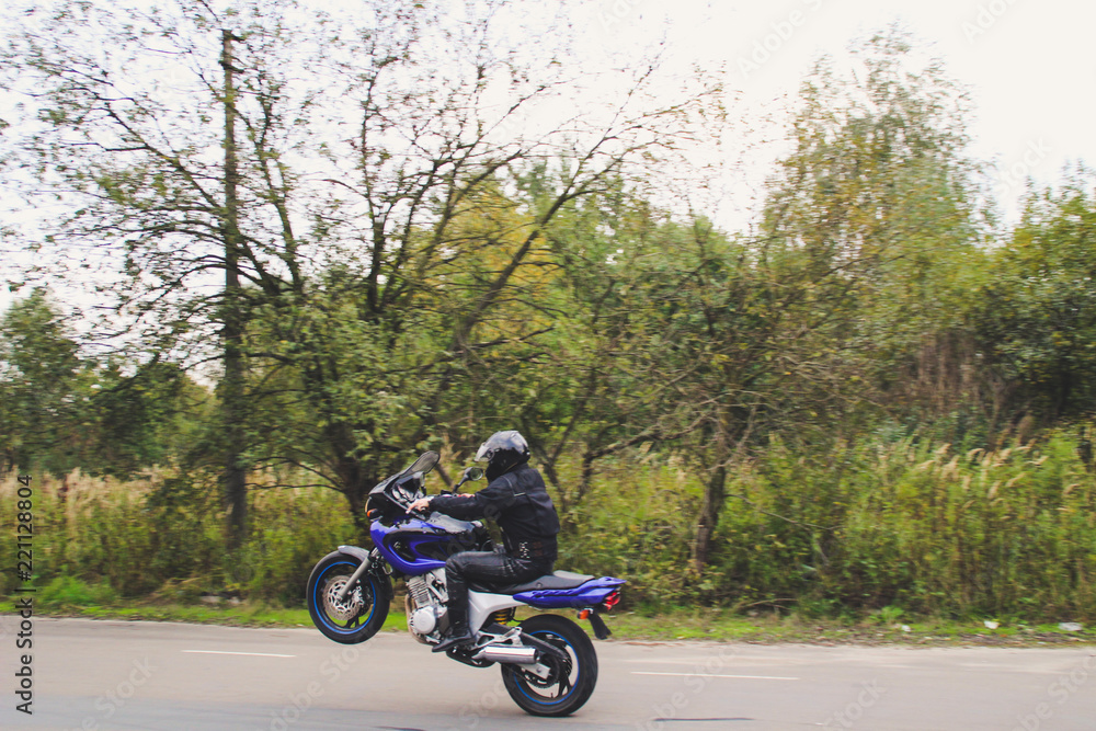 Dark blue motorbike on wheelie. Motorcycle on the parking lot. Ukraine, Lviv.