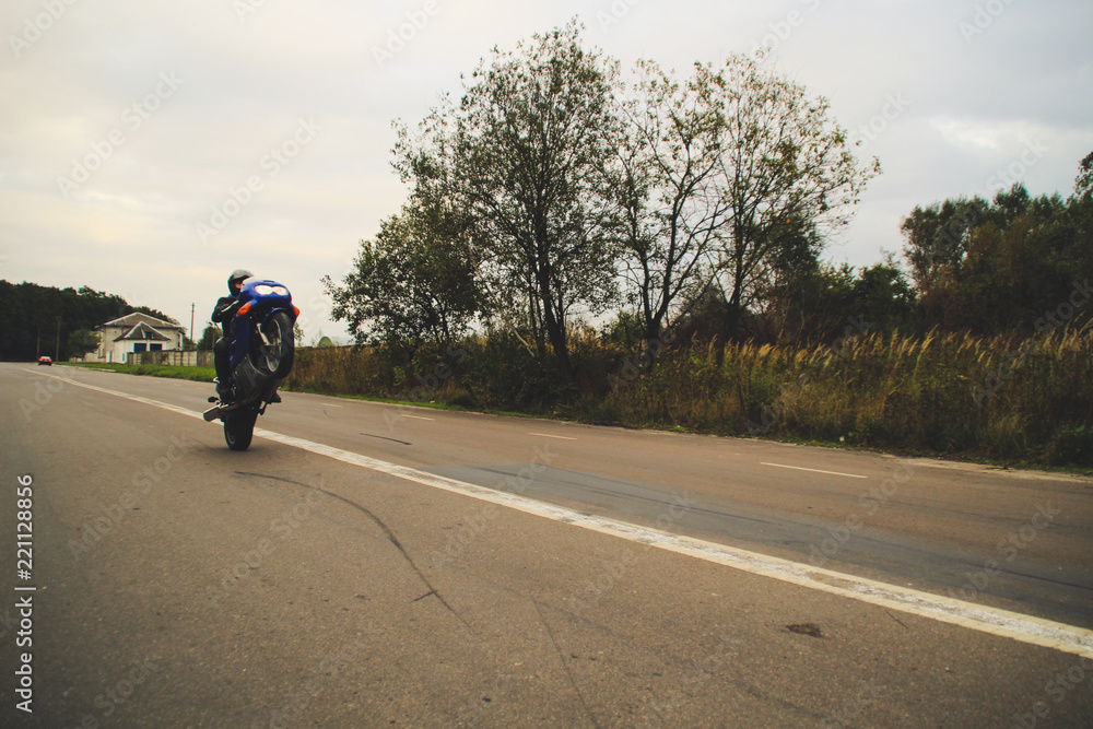Dark blue motorbike on wheelie. Motorcycle on the parking lot. Ukraine, Lviv. Dark blue motorbike on wheelie. Motorcycle on the parking lot. Ukraine, Lviv.