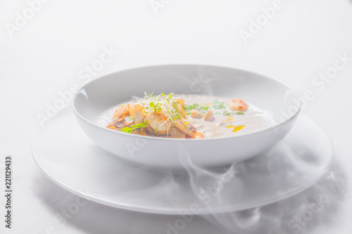 Cream mushroom soup with scallops, herbs, toast bread and dried ice mist.