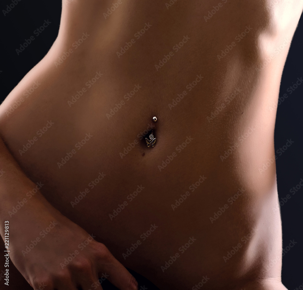Crop photo of perfect female body. Navel piercing Stock Photo | Adobe Stock
