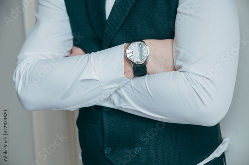 Man looking at luxury watch. The groom's wedding day.