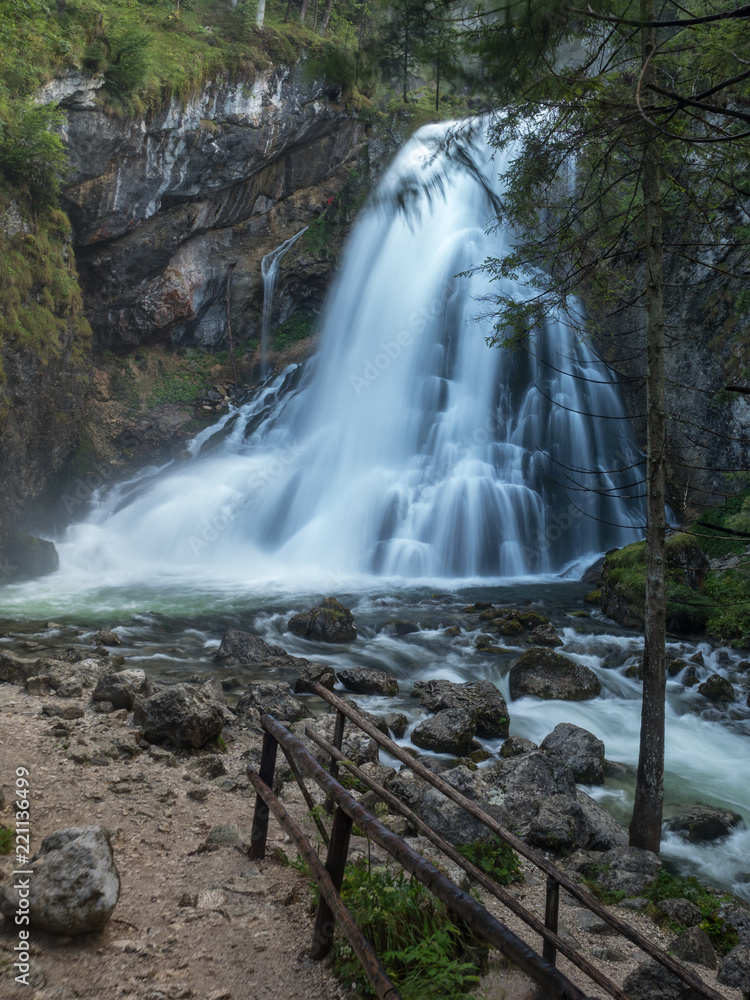 Obraz premium View of famous Gollinger Wasserfall with mossy rocks and green trees on a moody in springtime, Golling, Salzburger Land, Austria. August, 2018