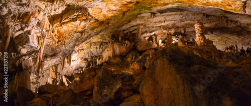 View of stalactites and stalagmites in an underground cavern - Postojna cave in Slovenia photo