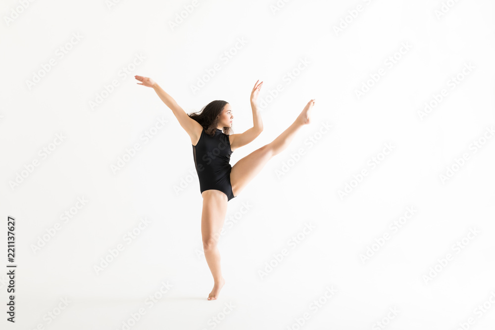 Female Performer Practicing Ballet Moves Over White Background Female Performer Practicing Ballet Moves Over White Background
