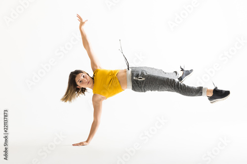 Portrait Of Young Female Break Dancer Doing Handstand