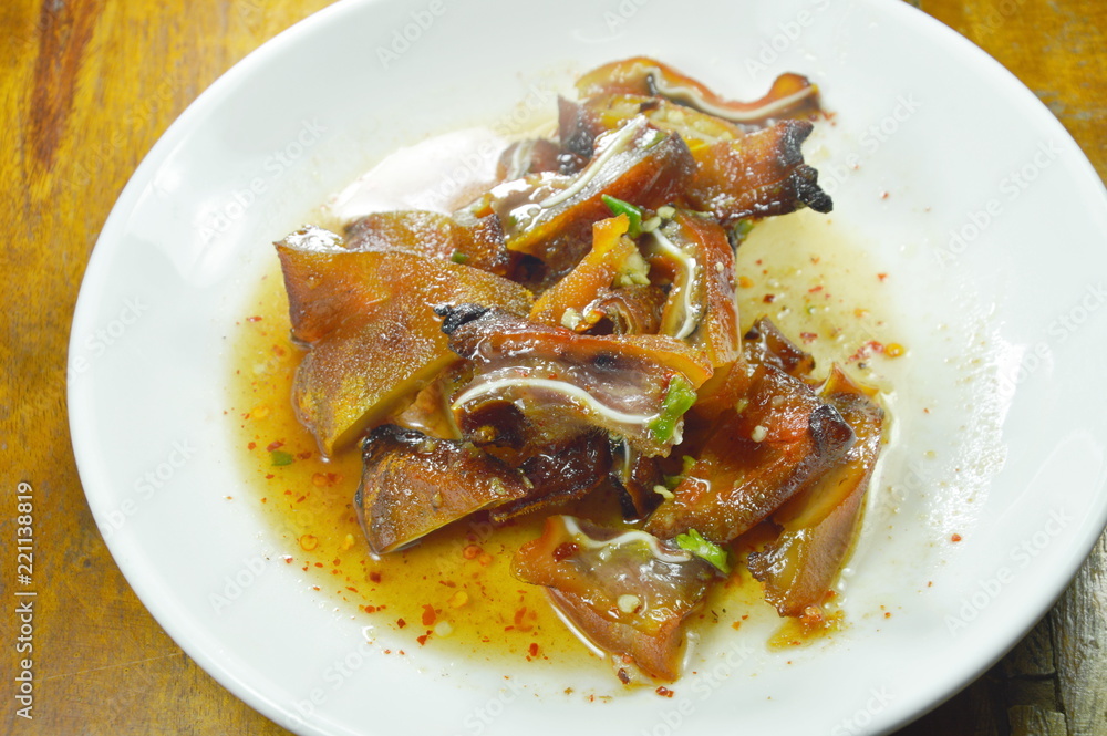 grilled pork ear slice dressing spicy sauce on plate grilled pork ear slice dressing spicy sauce on plate
