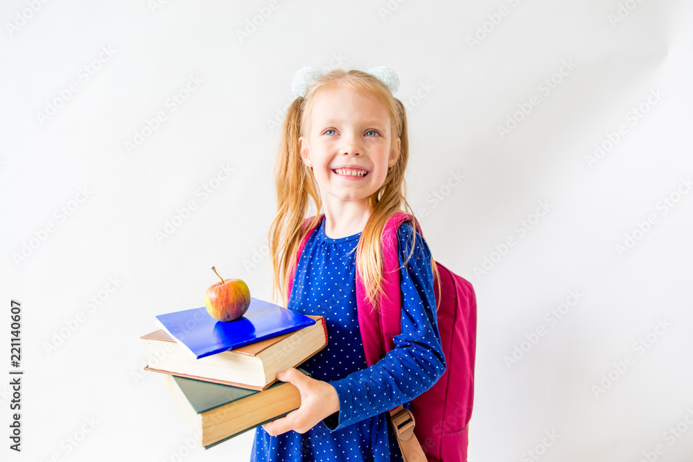 Happy cute industrious child is sitting at a desk indoors Happy cute industrious child is sitting at a desk indoors