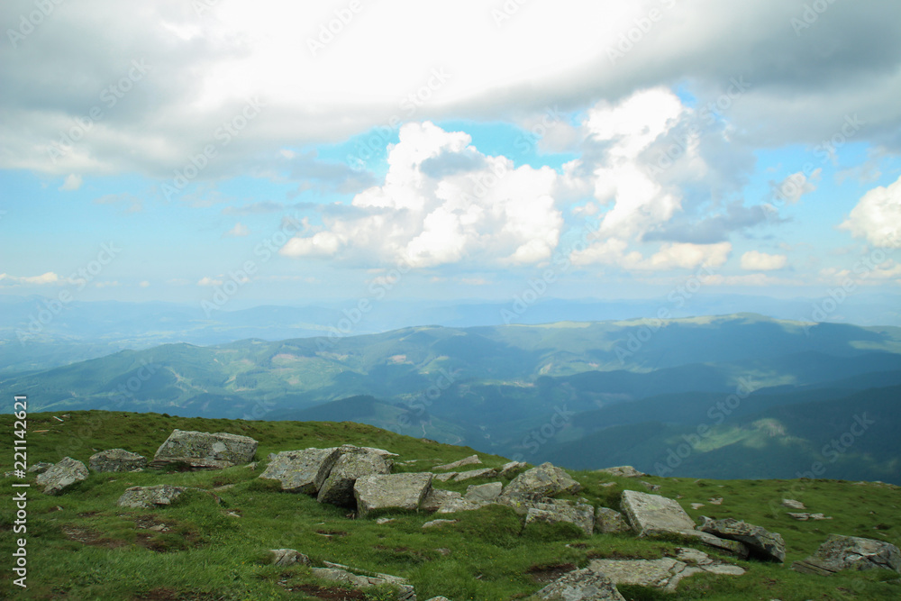 Fototapeta premium The summer green Carpathian mountains in Ukraine. The sky is over the mountains. Atmospheric landscapes while traveling on a jeep. Offroad expedition