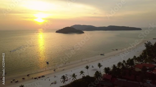 Drone high altitude Beautiful Orange sunset exotic tropical beach white sand  sun Embankment hotels roofs Palms. Horizon island Sea ocean. People Travel. Langkawi Malaysia Gavai Maldives. Drone photo