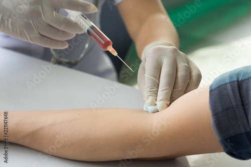 Close-up hands ,nurses holding a syringe with a liquid or vaccinations to patients using the syringe. Are treated by the use of sterile injectable arm. injection, antibody, influenza vaccine