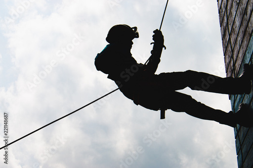 Silhouette High angle view of rappelling