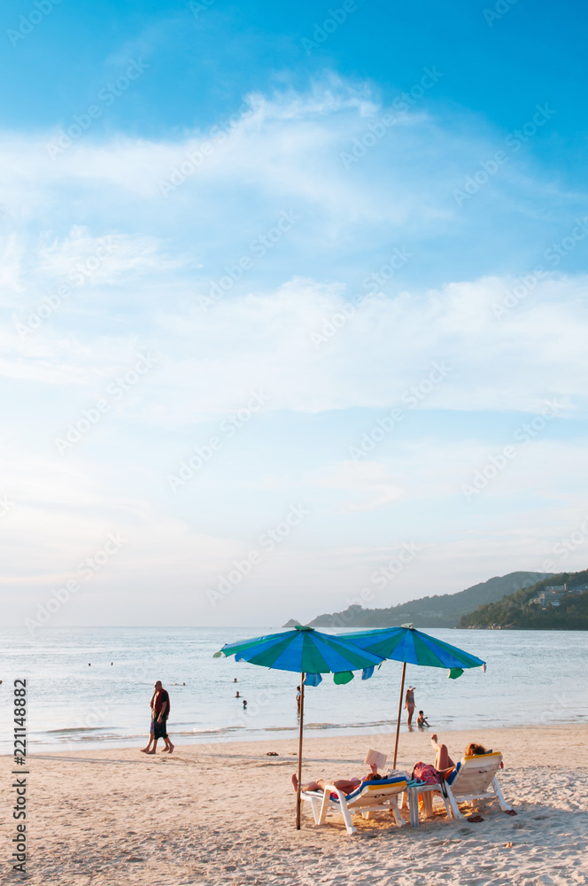 Phuket vibrant Patong beach with colourful umbrellas in evening