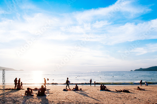 Phuket vibrant Patong beach with tourists in evening