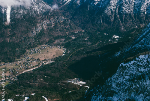 Breathtaking view of a steep snowy slope above the village. Austrian Alps. Beautiful dreamy landscape.