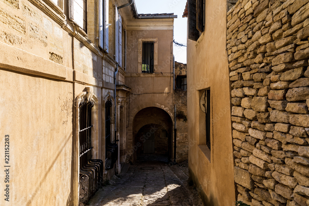 cozy narrow street with old stone buildings in provence, france