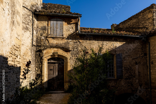 Fototapeta Naklejka Na Ścianę i Meble -  beautiful old stone building with wooden doors and shutters at sunny day, provence, france