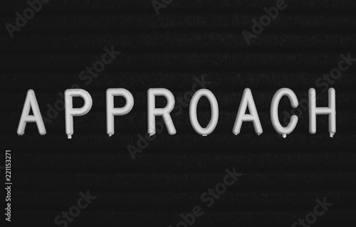 Word approach written on the letter board. White letters on the black background