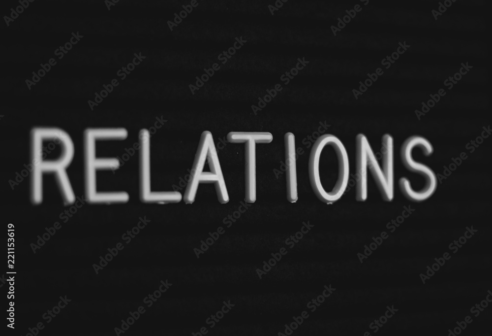 Word relations written on the letter board. White letters on the black background Word relations written on the letter board. White letters on the black background