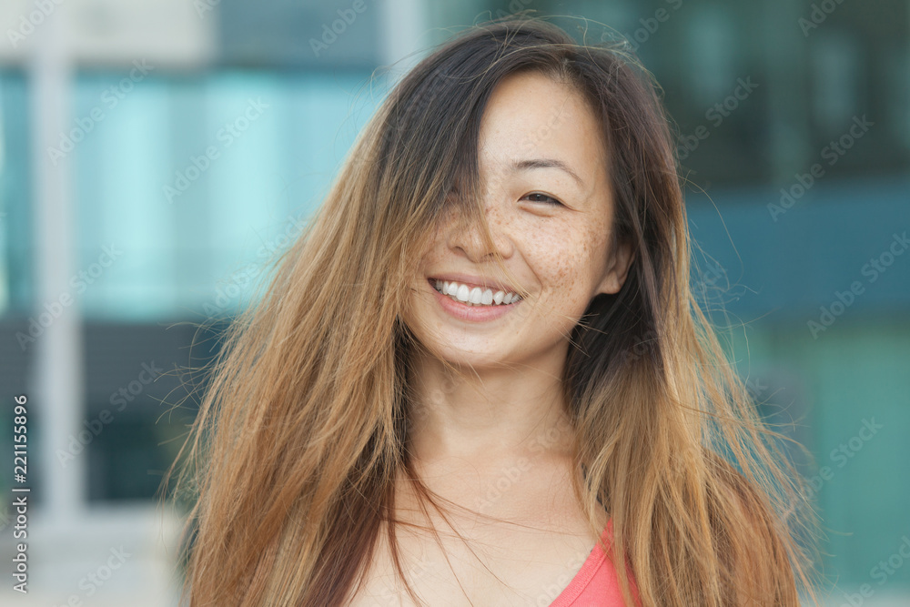 A portrait of a beautiful asian woman smiling brightly at the camera A portrait of a beautiful asian woman smiling brightly at the camera