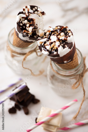 Two cornetto ice cream. Vanilla ice cream on wafle on white background photo