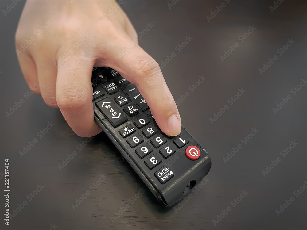 High Angle View of Hand Holding Remote Controller High Angle View of Hand Holding Remote Controller