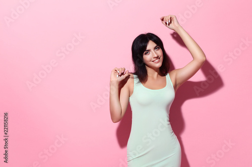 Fototapeta Naklejka Na Ścianę i Meble -  Young woman in white dress on pink background