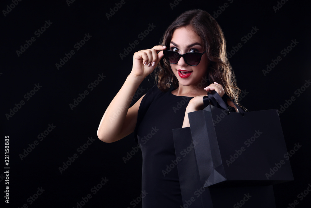 Happy woman with shopping bags on black background Happy woman with shopping bags on black background