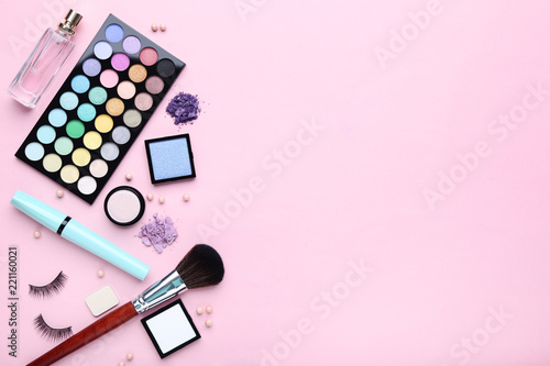Photography Different makeup cosmetics with perfume bottle on pink background
