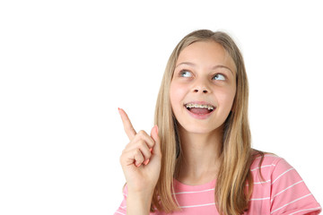 Young smiling girl with dental braces on white background