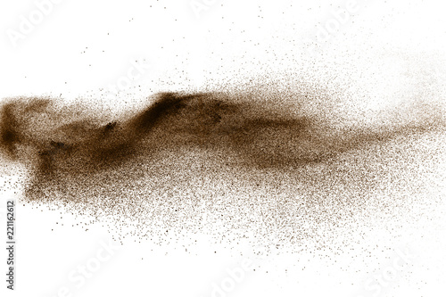 Deep Brown particles splattered on white background. Brown dust splash.