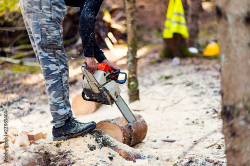 Cropped image of lumberjack working with chainsaw