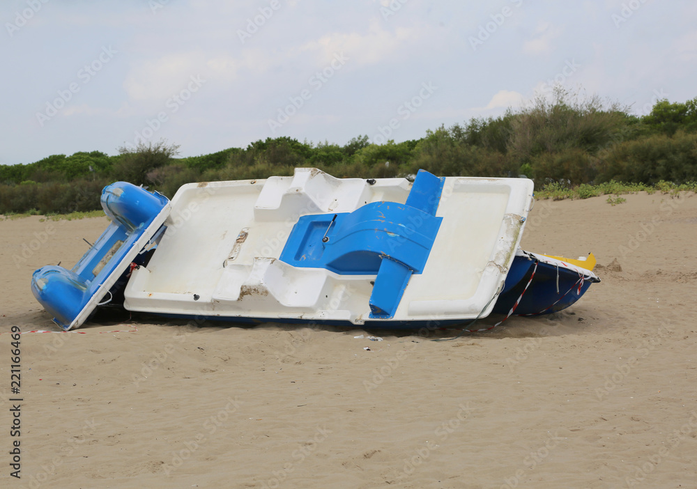 paddleboat destroyed on the beach
