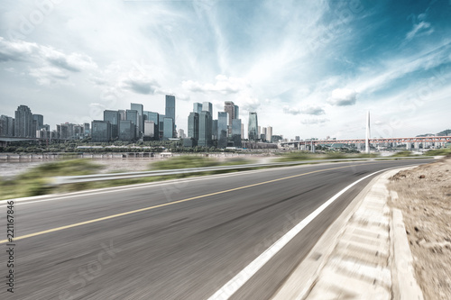 empty asphalt highway through modern city