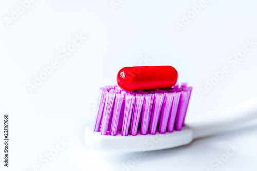 concept toothache with toothbrush and tablet at white background