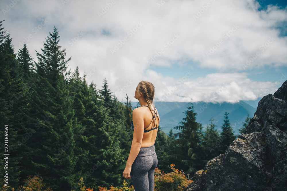 Naklejka premium Woman at a Vista in a Pacific Northwest Forest