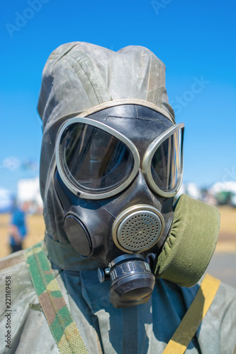 Portrait of human wearing hoodie and gas-mask photo