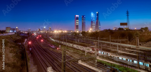 Night view of northern Madrid, Spain showing railroalds coming from the nearby chamartin station, the financial district with its skyscrapers (nicknamed las cuatro torres / the four towers). photo