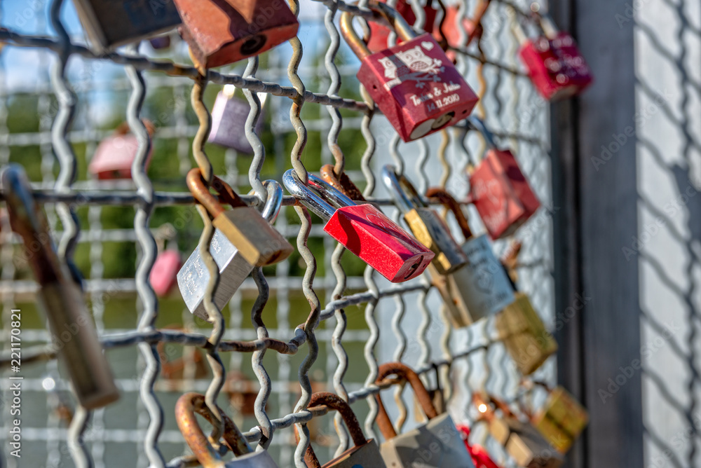 Various locks with names on a metal grid Various locks with names on a metal grid