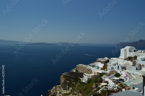 View Of Houses With Blue Vaulted Rooftop With View Of Bluish Aegean Sea In Oia Town Santorini Island. Architecture, Landscapes, Travel, Cruises. July 7, 2018. Santorini Island, Thera. Greece.