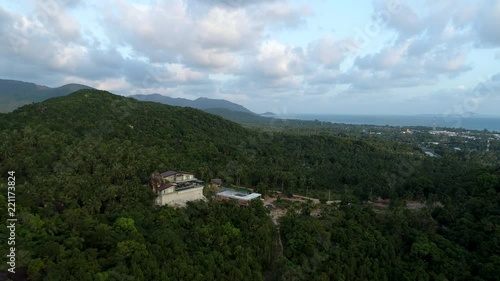 Wallpaper Mural 4k. Cinematic aerial footage. Flying above beautiful lush green jungle with palm trees and dense acacia trees growing on big mountains on tropical island in sunny summer. Drone footage. Torontodigital.ca