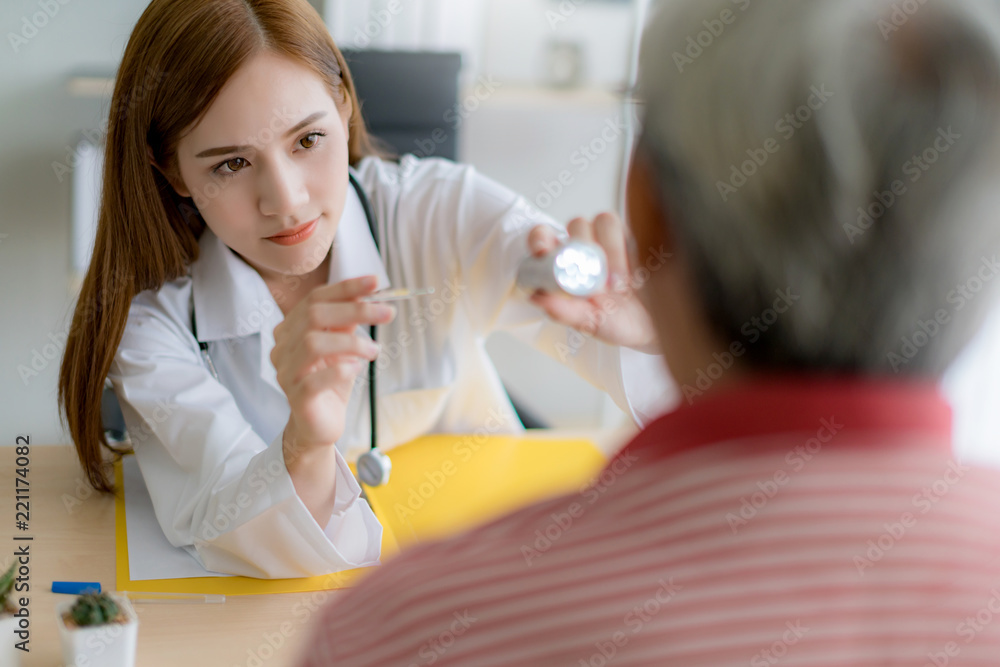 attractive asian doctor woman checking up tongue throat body system of senior asian patient at clinic hospital attractive asian doctor woman checking up tongue throat body system of senior asian patient at clinic hospital