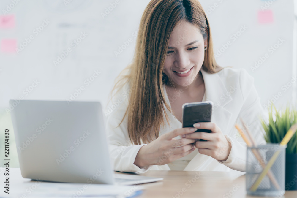 business asian woman enjoy with relax time hand touch smartphone with smile and happiness business asian woman enjoy with relax time hand touch smartphone with smile and happiness