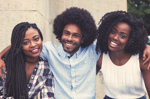 Laughing african american hipster man with two beautiful woman