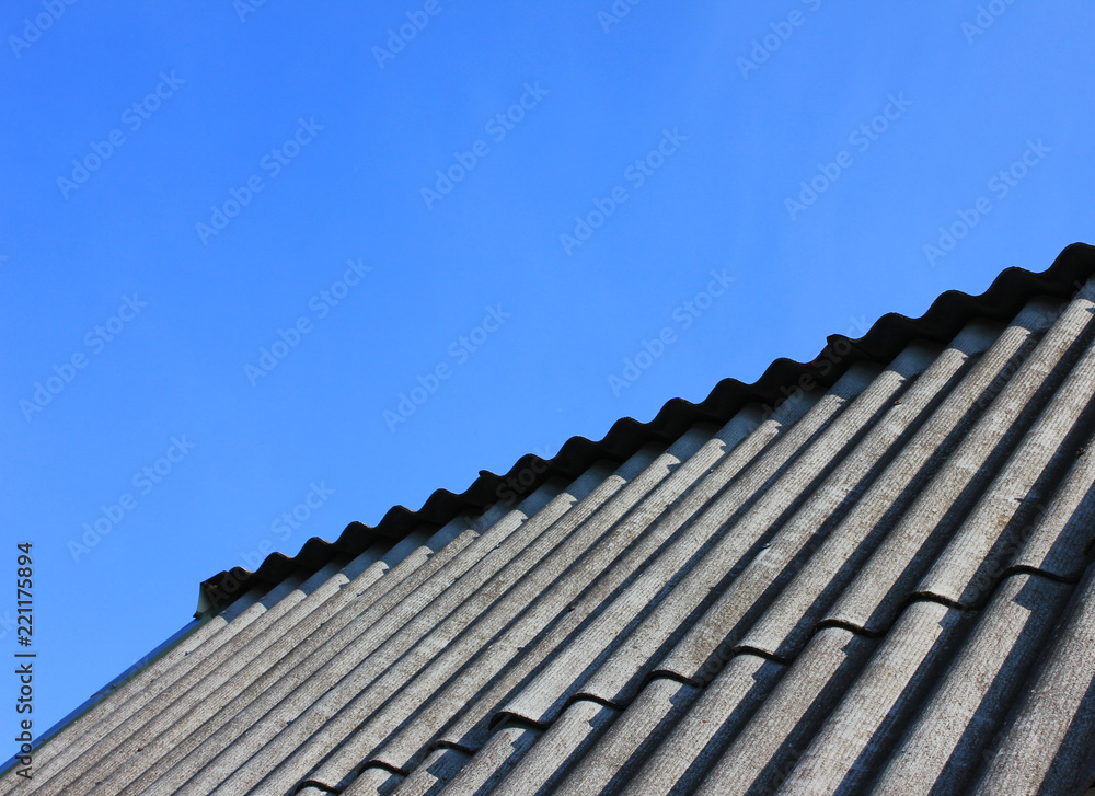 Rooftop Tiles at Countryside House Isolated on Empty Blue Sky Background. Construction Site Roofing Tiles and Modern Simple Roof Clad with Shingles on Sunny Summer Day Rooftop Tiles at Countryside House Isolated on Empty Blue Sky Background. Construction Site Roofing Tiles and Modern Simple Roof Clad with Shingles on Sunny Summer Day