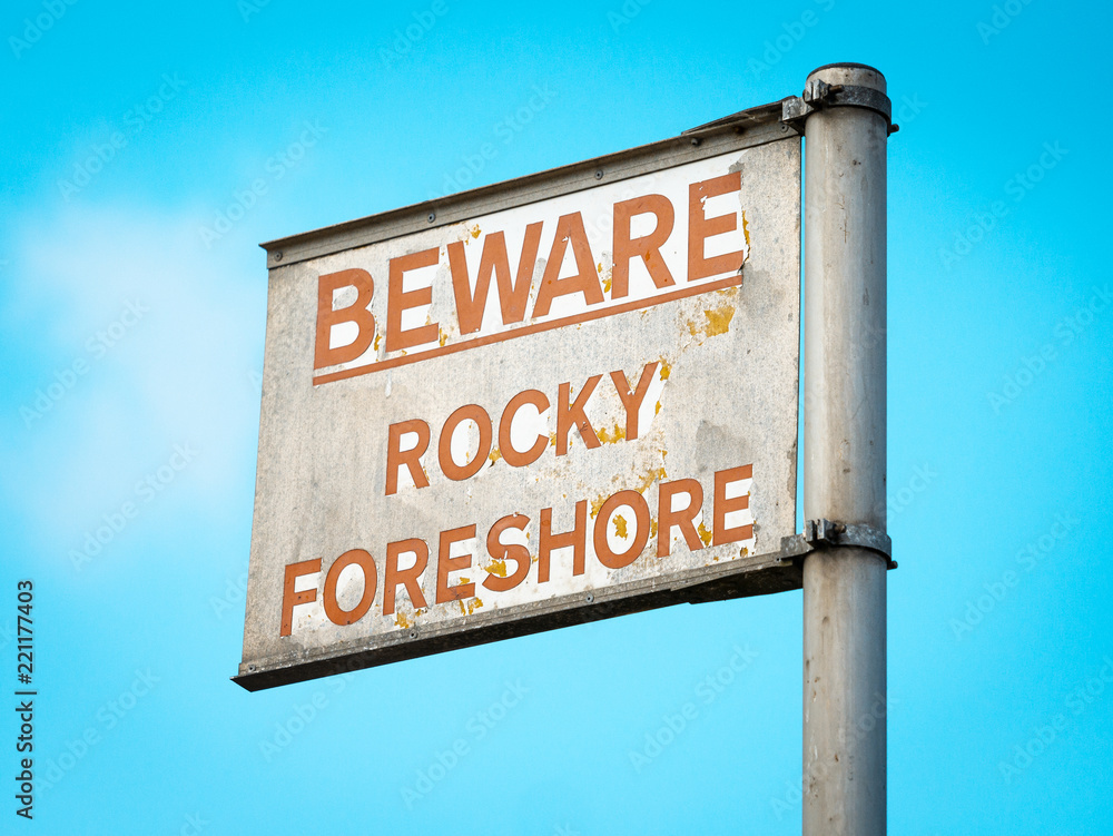 Fototapeta premium Beware Rocky Foreshore warning sign on Quayside