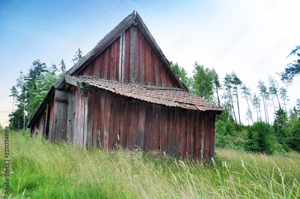 West Gotaland of Sweden - Old abandoed barn in the forest during summer. West Gotaland of Sweden - Old abandoed barn in the forest during summer.