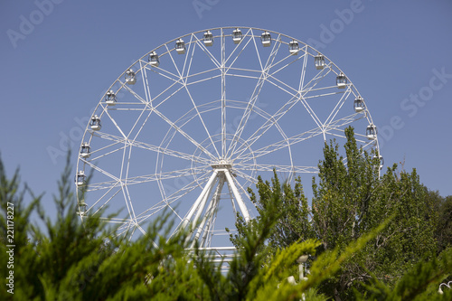 Ferris wheel against blue sky background Panoramic view © biggur