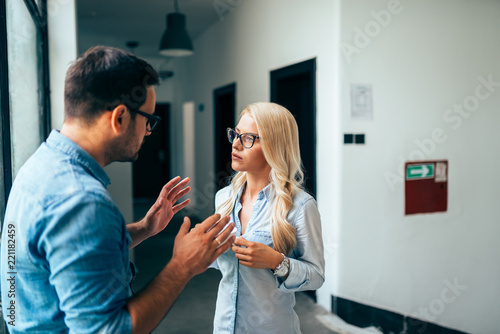 Wallpaper Mural Young couple or coworkers discussing in the lobby. Torontodigital.ca
