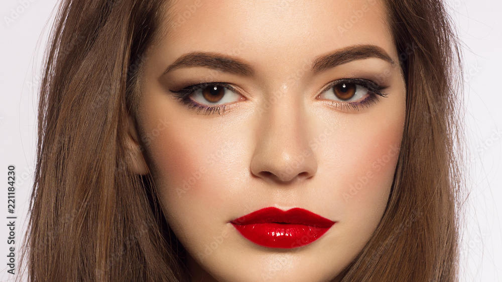 Close up portrait of a beautiful young female face with red lips and long brown hair. Classic make smoky shadows. Extremely long eyelashes and thick eyebrows. Cosmetology, spa, eyesight, lenses Close up portrait of a beautiful young female face with red lips and long brown hair. Classic make smoky shadows. Extremely long eyelashes and thick eyebrows. Cosmetology, spa, eyesight, lenses