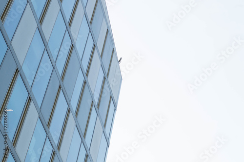 Minimalist architecture pointing into the bright sunny sky with geommetrical lines and windows